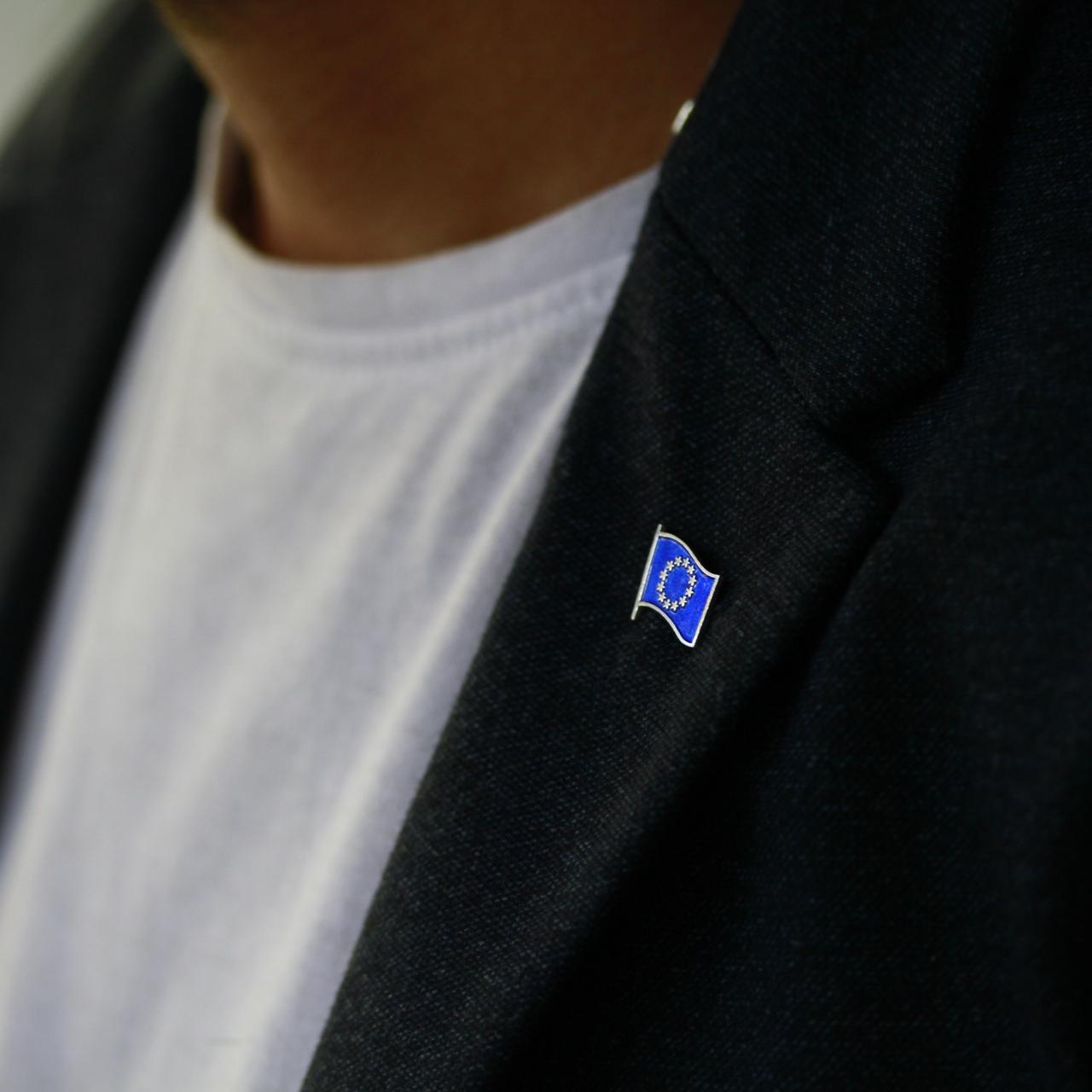 EU flag pin on a dark blazer